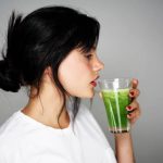 Young woman drinking healthy detox